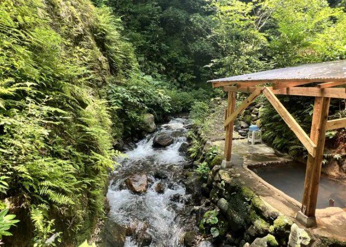 The lush nature and rushing river of Myoban hot springs.